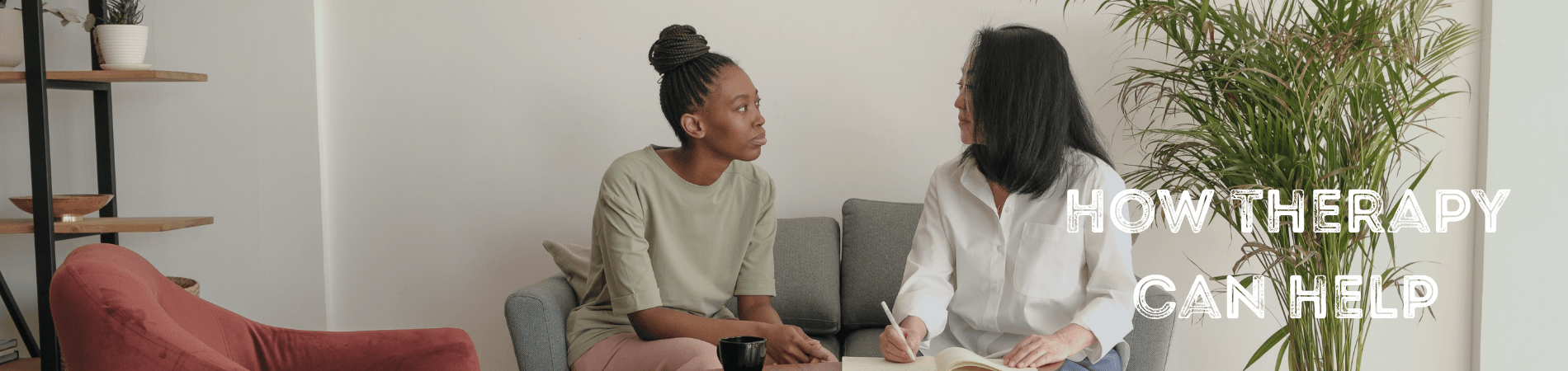 Two women sitting on a sofa having a meeting.