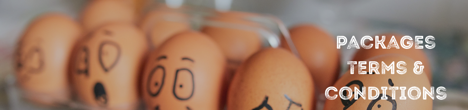 A dozen eggs with different faces drawn on them in black ink.