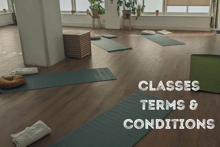 A studio with 4 yoga mats and cushions.