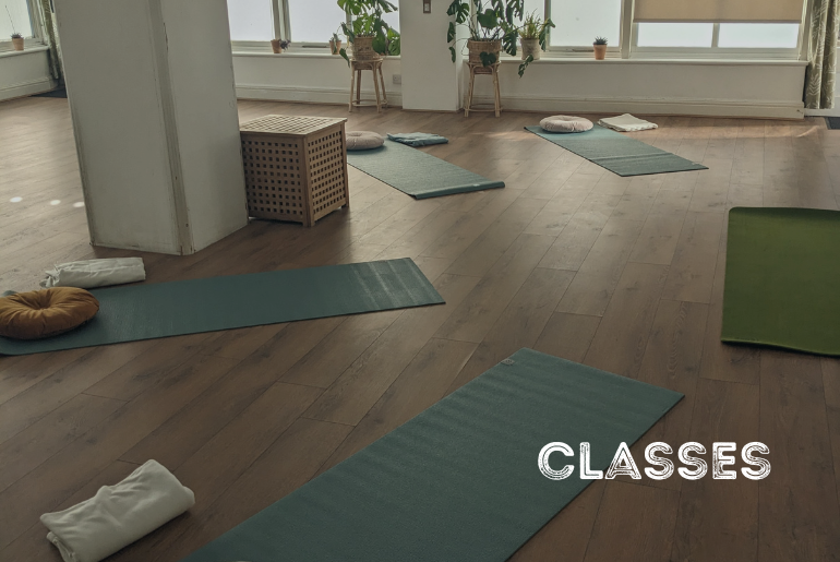 Yoga mats laid out in a semi circle in a yoga studio