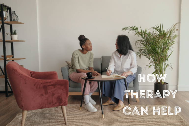 Two women sitting on a sofa having a meeting.