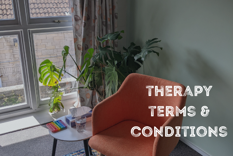 An empty orange chair in a therapy room setting.