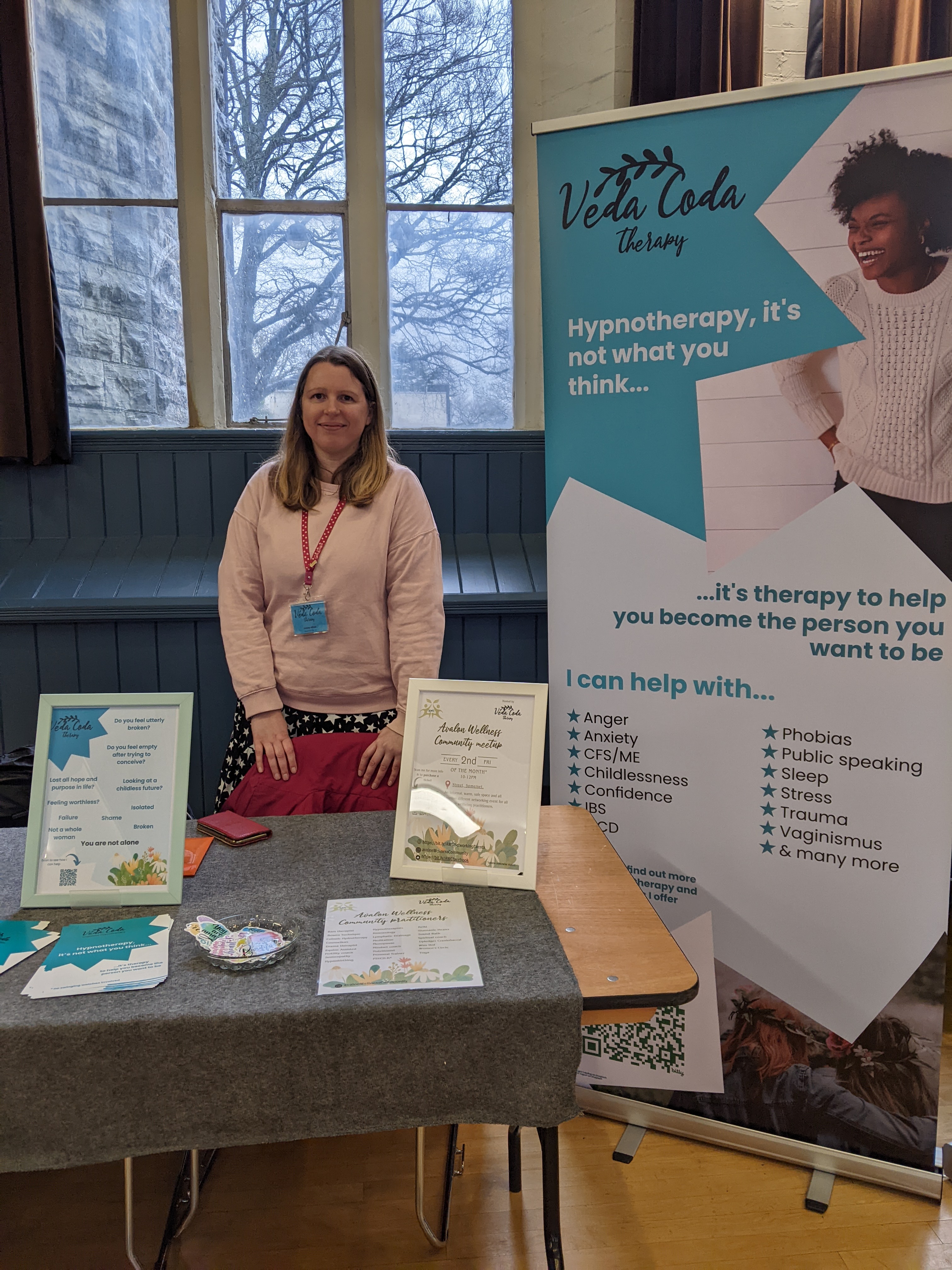 Lindsay standing behind her stall at her health and wellbeing event